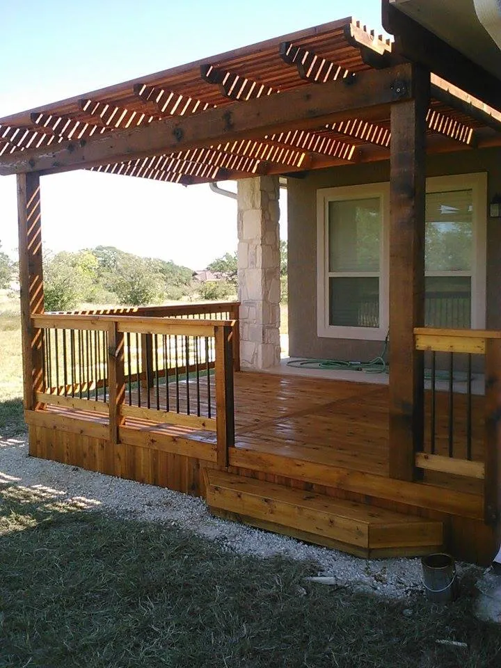 Pergola covered stained deck on a Hill Country stone and stucco home